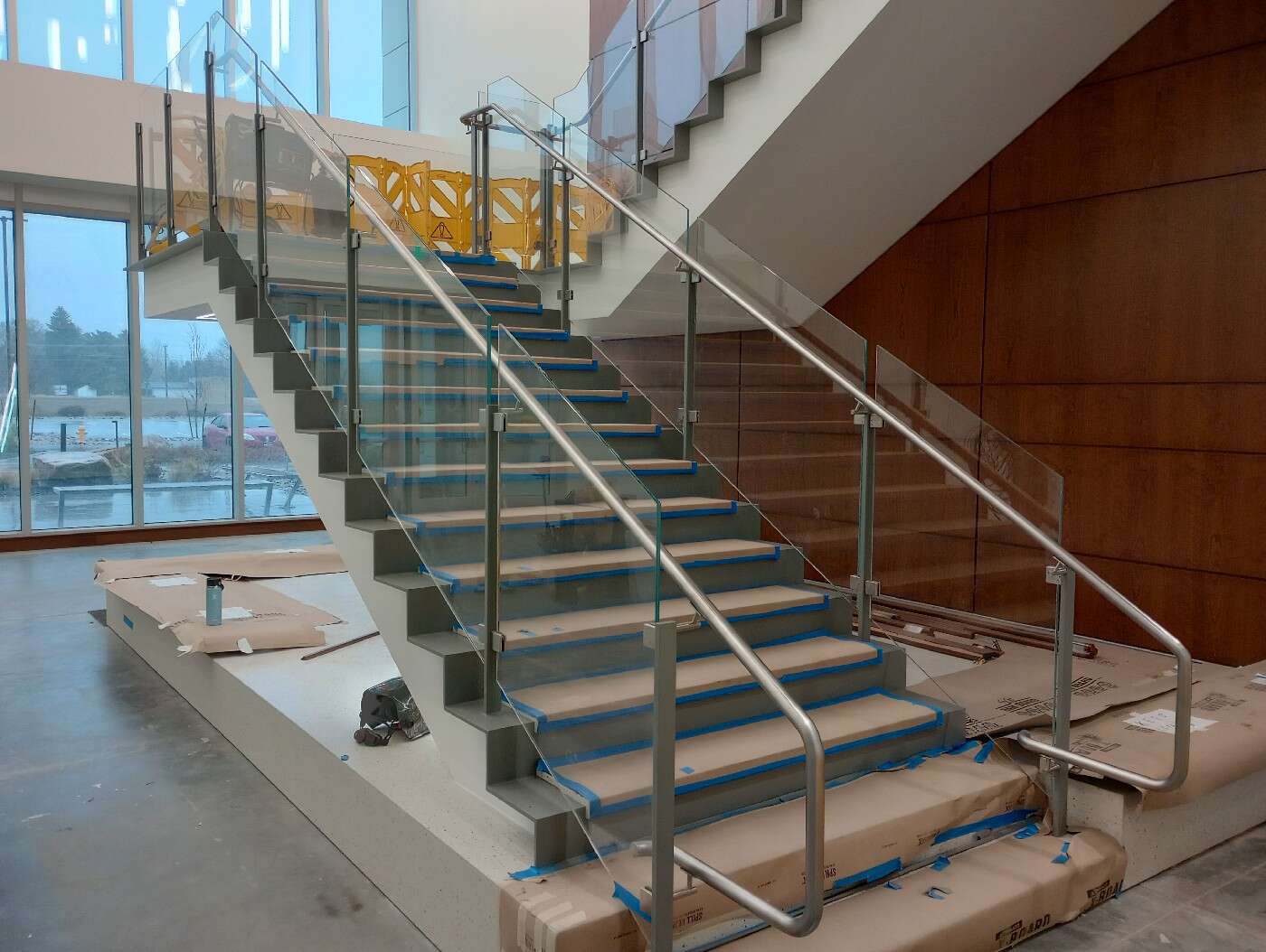 Glass panel railing and stainless steel handrail on a commercial stair